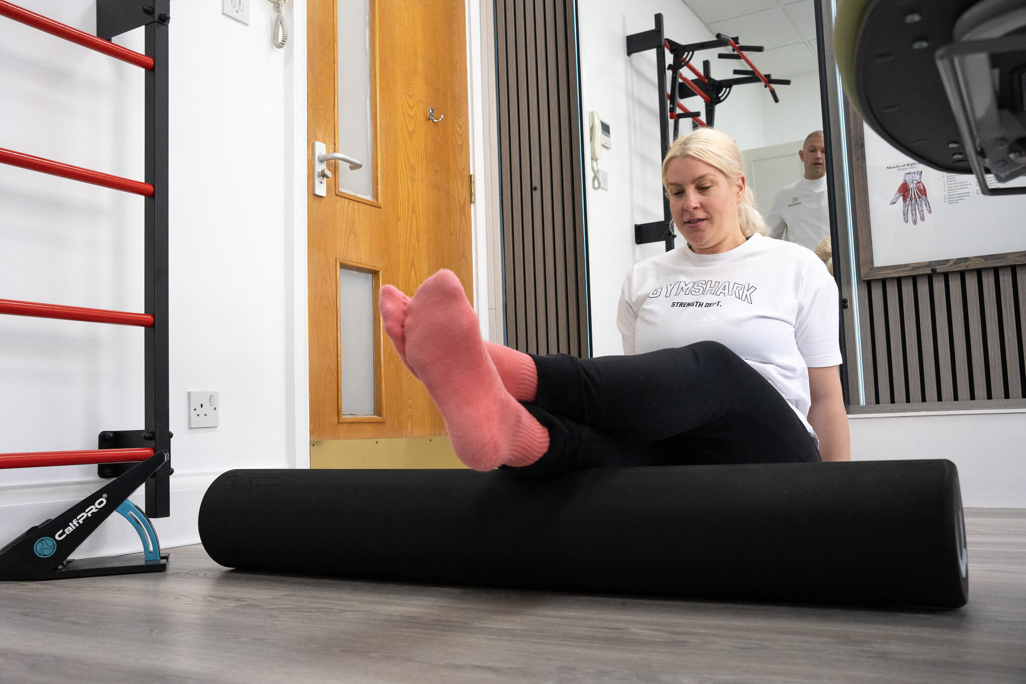 DSC06049 woman doing exercises on a roller on her legs